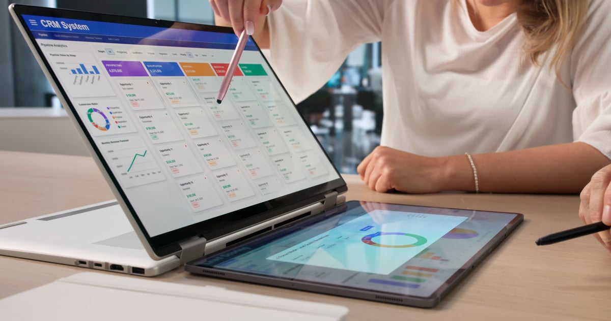Sales manager and marketing coach analyzing CRM data for client growth